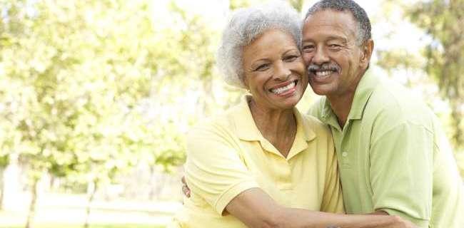 Senior Couple Riding Bikes In Park